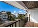Lovely street view from the balcony, featuring a wood ceiling and deck, plus a railing at 2213 Avenue C, Bradenton Beach, FL 34217