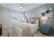 Inviting bedroom with cool blue color scheme, comfortable bed, and stylish nightstands, illuminated by natural light at 2213 Avenue C, Bradenton Beach, FL 34217