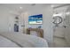 Comfortable bedroom with a mounted flat screen television and view into a bathroom at 2213 Avenue C, Bradenton Beach, FL 34217