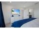 Comfortable bedroom with a mounted flat screen television and a view into the bathroom at 2213 Avenue C, Bradenton Beach, FL 34217