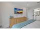 Modern bedroom with a sleek entertainment center and en suite bathroom access at 2213 Avenue C, Bradenton Beach, FL 34217