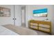 Bright bedroom featuring a sleek dresser and an open doorway into a bathroom with modern finishings at 2213 Avenue C, Bradenton Beach, FL 34217