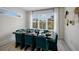 Dining room with large window, modern table setting, and decorative wall art at 2213 Avenue C, Bradenton Beach, FL 34217