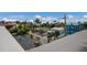 Coastal home exterior with blue siding, rooftop views, and tropical foliage at 2213 Avenue C, Bradenton Beach, FL 34217