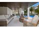 Outdoor lounge area with comfortable seating by the pool, perfect for relaxing and entertaining at 2213 Avenue C, Bradenton Beach, FL 34217