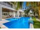 Beautiful outdoor pool featuring a water feature, with lounge seating and lush landscaping at 2213 Avenue C, Bradenton Beach, FL 34217