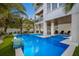 Beautiful outdoor pool featuring a water feature, with lounge seating and lush landscaping at 2213 Avenue C, Bradenton Beach, FL 34217
