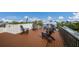 This rooftop deck has beautiful water views and four chairs for relaxing in the sun at 2213 Avenue C, Bradenton Beach, FL 34217