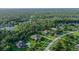 Aerial view of a private estate surrounded by mature trees and ponds at 22343 Panther Loop, Bradenton, FL 34202