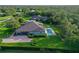 Aerial view showing the home's backyard oasis, including pool, patio, and extensive lawn at 22343 Panther Loop, Bradenton, FL 34202