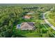 A stunning aerial view of the property showcasing the backyard pool, lawn, and surrounding community at 22343 Panther Loop, Bradenton, FL 34202