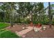 Secluded backyard featuring brick patio seating area surrounded by mature trees at 22343 Panther Loop, Bradenton, FL 34202