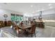 Dining room open to kitchen with large table, bar seating, and backyard views at 22343 Panther Loop, Bradenton, FL 34202