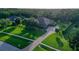 Beautiful home exterior with meticulously manicured lawn, mature trees, and long paver driveway at 22343 Panther Loop, Bradenton, FL 34202