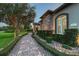 Charming exterior featuring stone accents, a well-maintained walkway, and manicured landscaping at 22343 Panther Loop, Bradenton, FL 34202