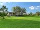 Estate home featuring large manicured front yard with mature trees at 22343 Panther Loop, Bradenton, FL 34202