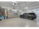 The large garage features storage, and a vehicle with an electric charging cord at 22343 Panther Loop, Bradenton, FL 34202