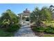 A charming gazebo set amongst palm trees, landscaped bushes and a crushed-shell path offers a serene community gathering place at 22343 Panther Loop, Bradenton, FL 34202