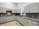 Efficient kitchen layout with granite countertops, stainless steel appliances, and ample cabinet space at 22343 Panther Loop, Bradenton, FL 34202