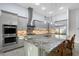 Gourmet kitchen featuring stainless steel appliances, a granite island, and custom cabinetry at 22343 Panther Loop, Bradenton, FL 34202