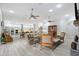 Expansive living area showcasing an open layout with a fireplace, comfortable furniture, and easy access to kitchen at 22343 Panther Loop, Bradenton, FL 34202