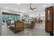 Open-concept living space with kitchen, dining, and lounge areas featuring tile floors and seamless indoor/outdoor living at 22343 Panther Loop, Bradenton, FL 34202