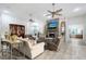Bright living room with stone fireplace, ceiling fans, comfortable seating, and seamless flow into other areas at 22343 Panther Loop, Bradenton, FL 34202