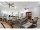 Spacious living room features ceiling fans, skylights, and seamless flow to kitchen and dining area at 22343 Panther Loop, Bradenton, FL 34202