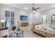 Serene main bedroom featuring ample natural light, a ceiling fan, and a seating area; ideal for relaxation at 22343 Panther Loop, Bradenton, FL 34202
