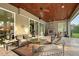 Comfortable outdoor living area with a stone fireplace and seating, perfect for relaxation at 22343 Panther Loop, Bradenton, FL 34202