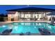 Stunning backyard pool at twilight with open-plan living areas and covered patio at 22343 Panther Loop, Bradenton, FL 34202