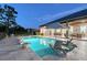 Backyard oasis featuring a pool with sun loungers, an umbrella, an outdoor dining area and exterior home views at 22343 Panther Loop, Bradenton, FL 34202