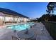 Backyard pool with travertine tile, patio furniture and views of the house at 22343 Panther Loop, Bradenton, FL 34202