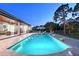 Relaxing pool area with lounge chairs, umbrella, and covered patio; an ideal outdoor oasis at 22343 Panther Loop, Bradenton, FL 34202