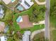 Aerial view of a private pool and spacious backyard next to the home with a brown roof and adjacent to a road at 2430 Catalonia S Way, St Petersburg, FL 33712