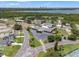 Aerial view of the St. Petersburg Country Club buildings, parking lot and golf course near a beautiful lake at 2430 Catalonia S Way, St Petersburg, FL 33712