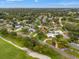 Birds eye view of a property surrounded by lush green foliage and golf courses, showing beautiful landscaping in a desirable location at 2430 Catalonia S Way, St Petersburg, FL 33712