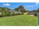 Spacious backyard with lush green grass and manicured landscaping at 2430 Catalonia S Way, St Petersburg, FL 33712