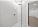 Modern bathroom featuring a glass-enclosed shower, neutral tiling, and brushed gold fixtures at 2430 Catalonia S Way, St Petersburg, FL 33712
