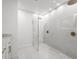 Modern bathroom featuring a glass-enclosed shower, neutral tiling, and brushed gold hardware at 2430 Catalonia S Way, St Petersburg, FL 33712