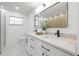 Beautiful bathroom featuring dual sinks and wood accent wall at 2430 Catalonia S Way, St Petersburg, FL 33712