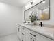 Modern bathroom featuring dual sinks, white countertops, and dark hardware at 2430 Catalonia S Way, St Petersburg, FL 33712