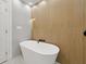 Modern bathroom with standalone tub and wood accent wall at 2430 Catalonia S Way, St Petersburg, FL 33712