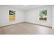 Bright bedroom with wood-look floors, natural light from two windows at 2430 Catalonia S Way, St Petersburg, FL 33712