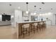 Contemporary kitchen with pendant lights, island seating, and seamless flow to the living area at 2430 Catalonia S Way, St Petersburg, FL 33712