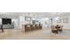 Open-concept kitchen with a large island, modern pendant lighting, and a view into the living space at 2430 Catalonia S Way, St Petersburg, FL 33712