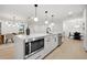 Modern kitchen with white cabinets, stainless steel appliances, and pendant lighting at 2430 Catalonia S Way, St Petersburg, FL 33712