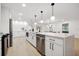 Bright, modern kitchen with stainless appliances, white cabinetry and an open concept layout at 2430 Catalonia S Way, St Petersburg, FL 33712