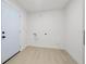 Clean, bright laundry room with modern flooring and door to exterior at 2430 Catalonia S Way, St Petersburg, FL 33712