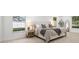 Brightly lit main bedroom with large windows, a king-size bed, and neutral tones at 2430 Catalonia S Way, St Petersburg, FL 33712